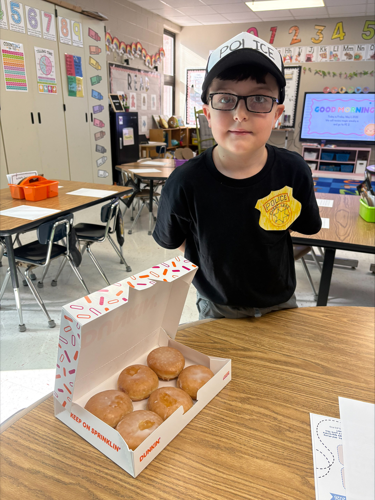 student dressed up as police officer with donuts