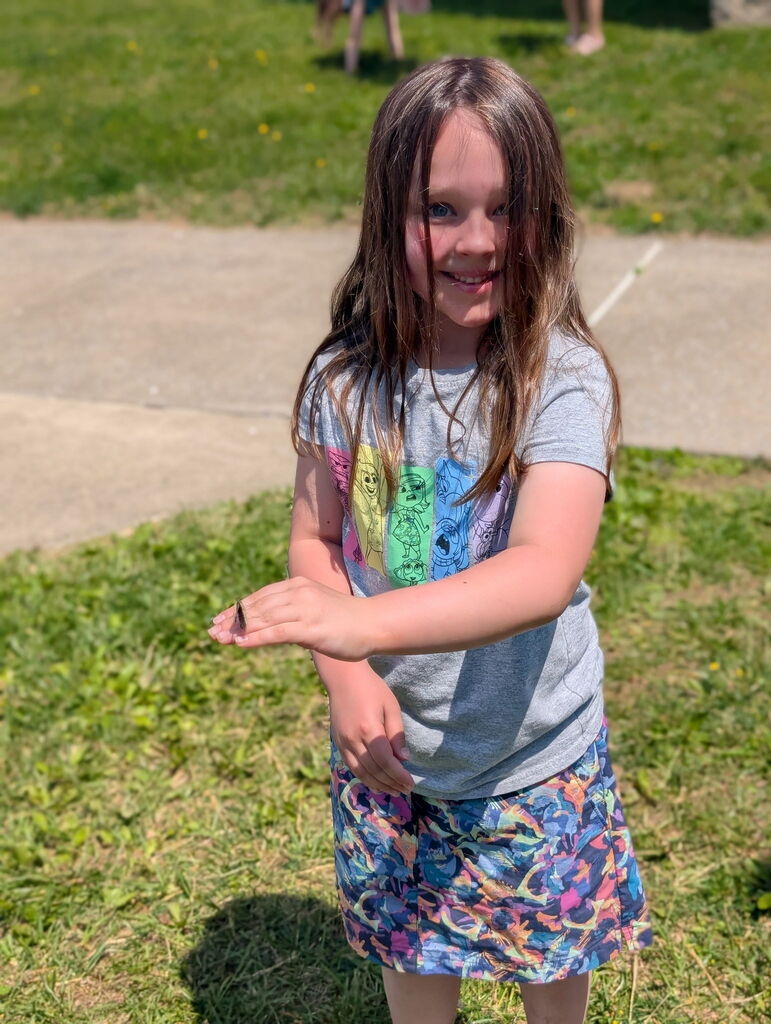 Student holding a butterfly