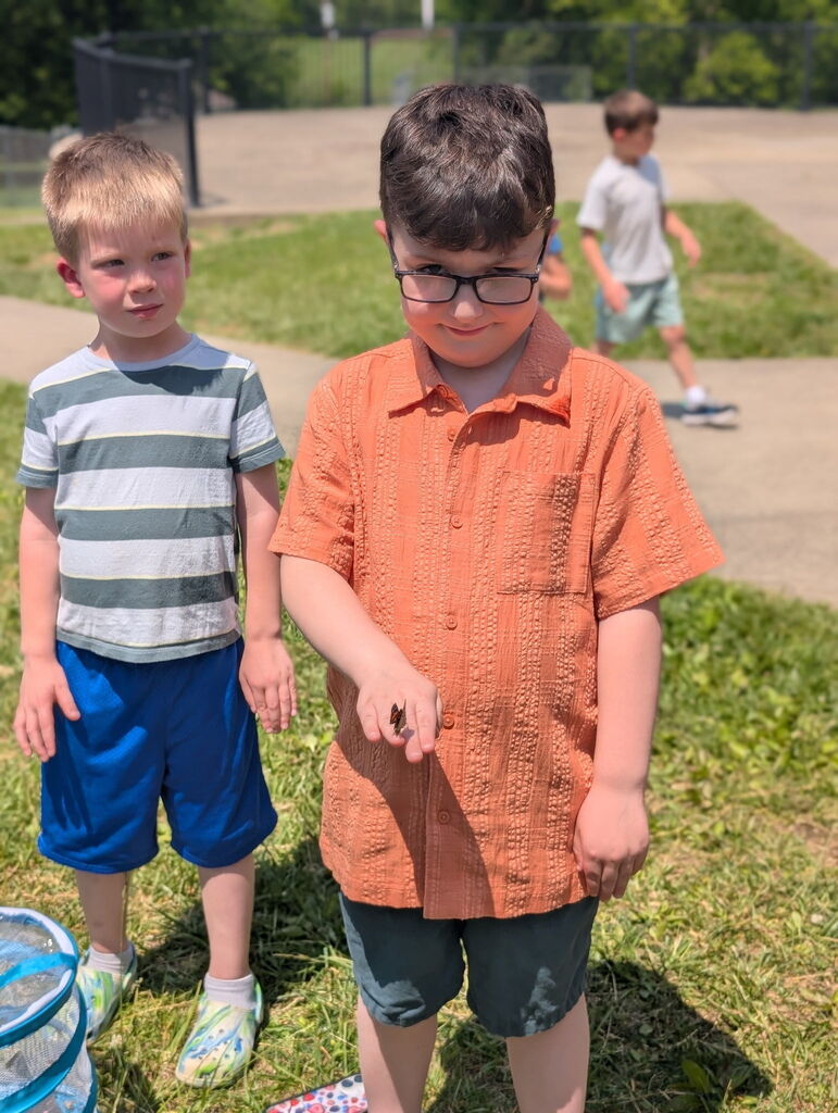 Student holding a butterfly