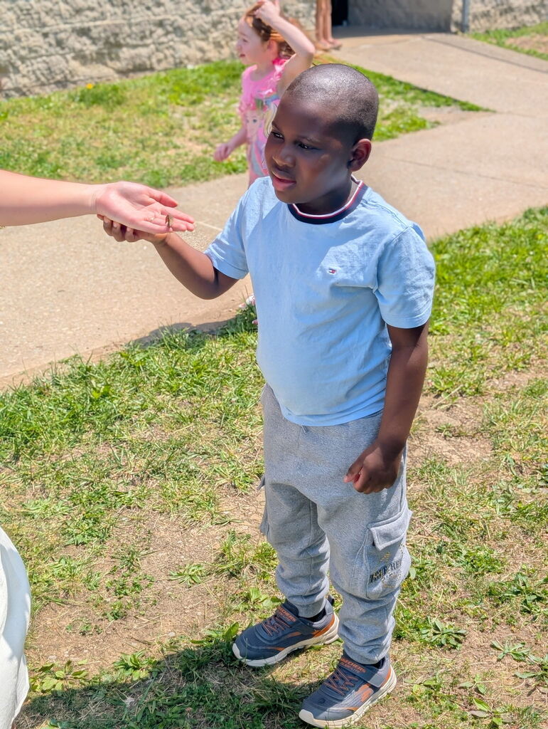 Student holding a butterfly