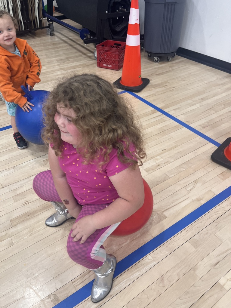 Girl bouncing on ball