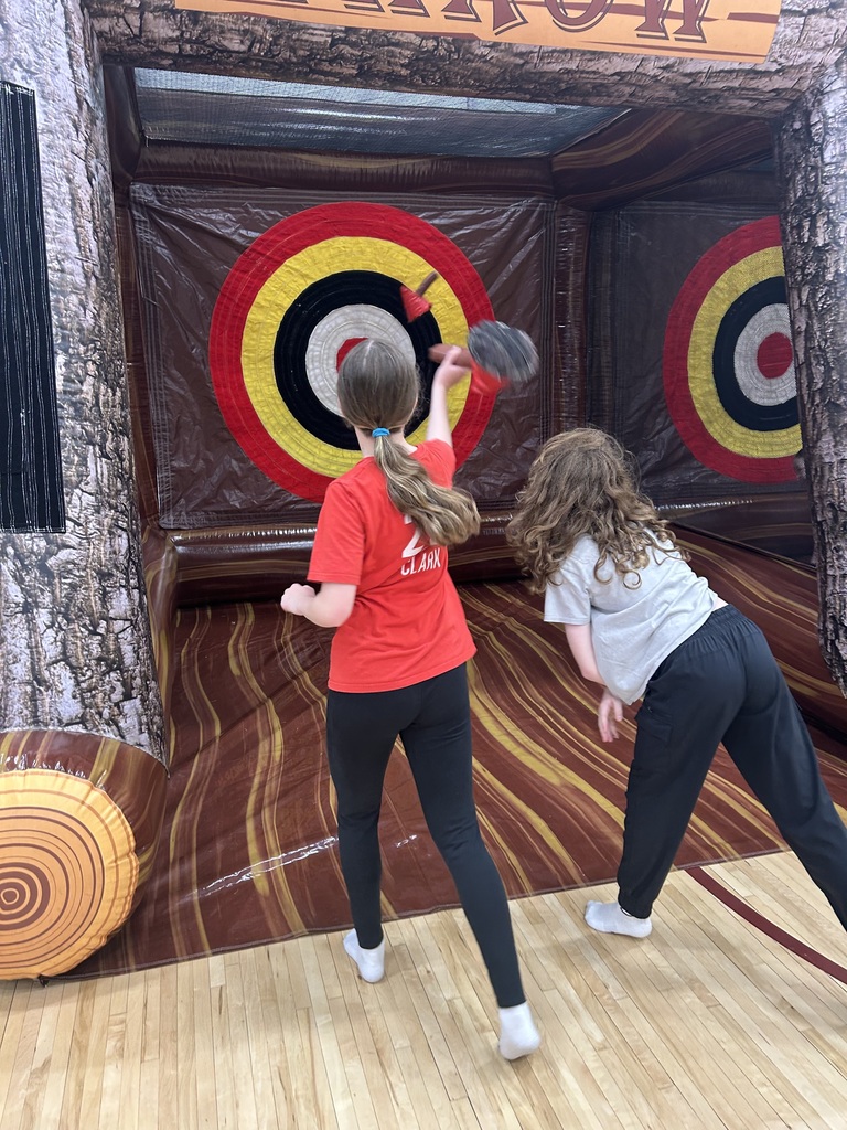 2 students are throwing things at an inflatable target.