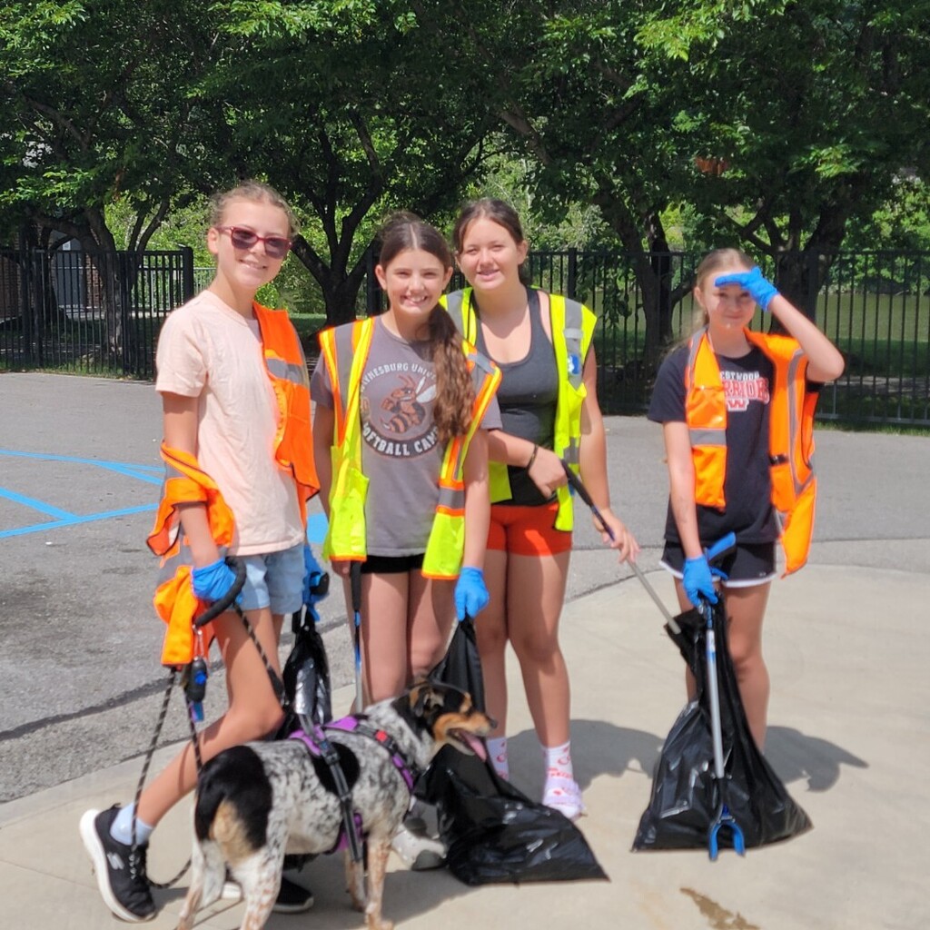 Students cleaning up street.
