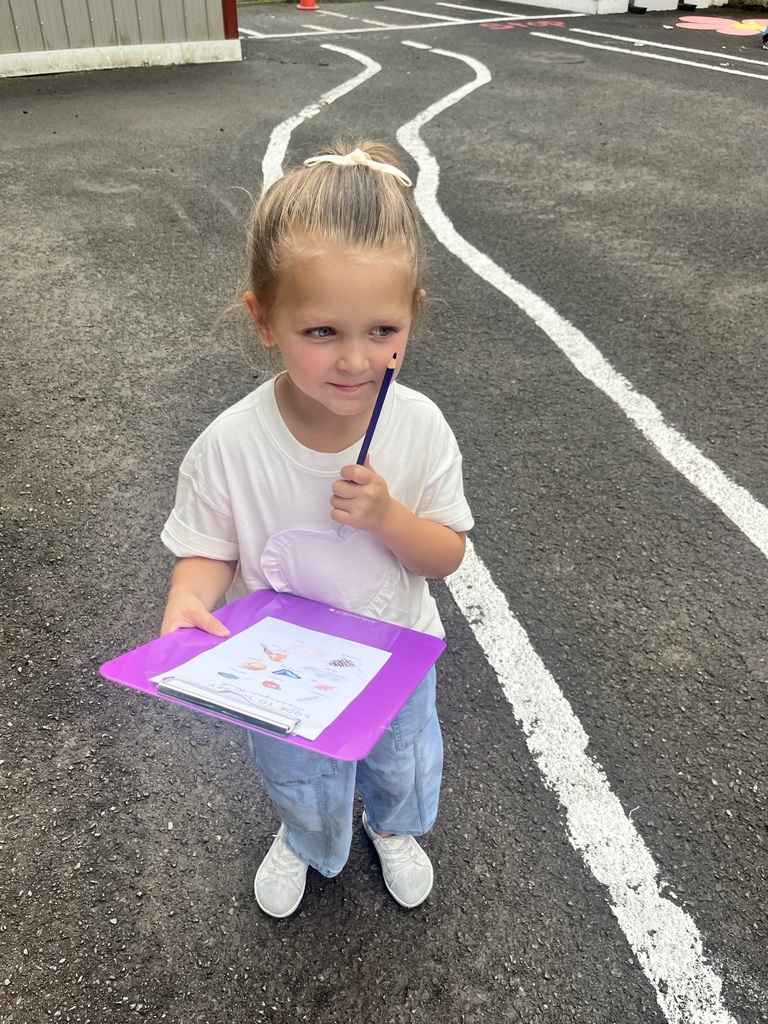 Pre K student with a clipboard