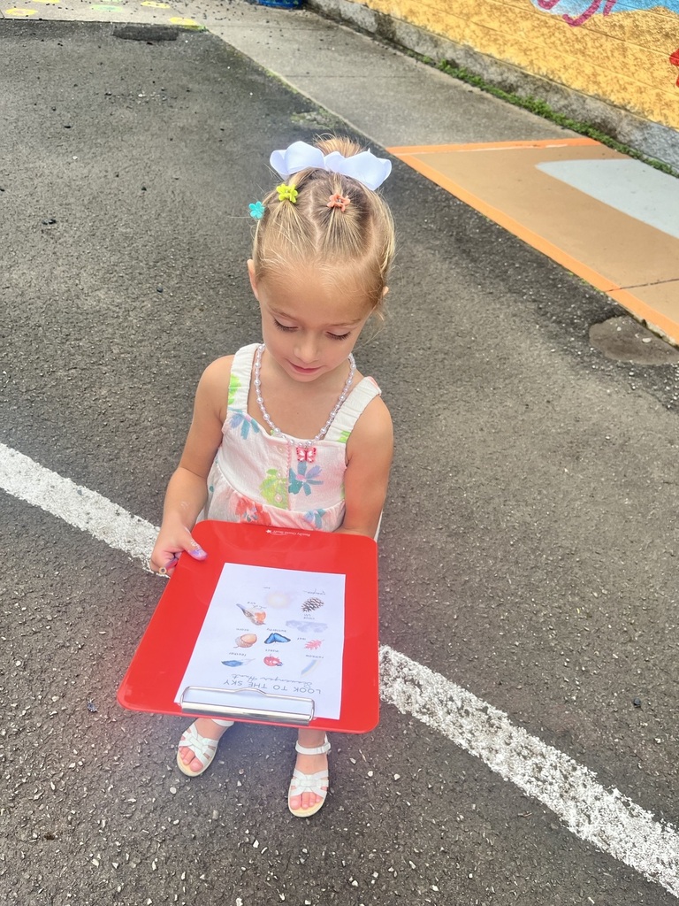 PreK student with a clipboard