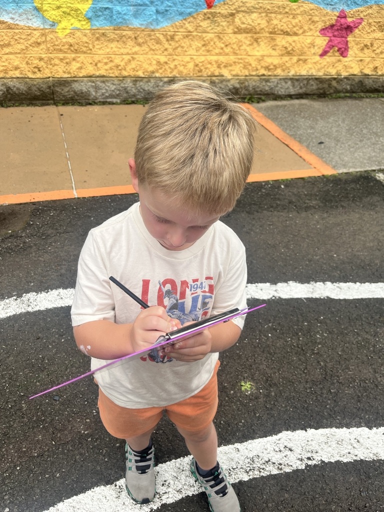 PreK student with a clipboard