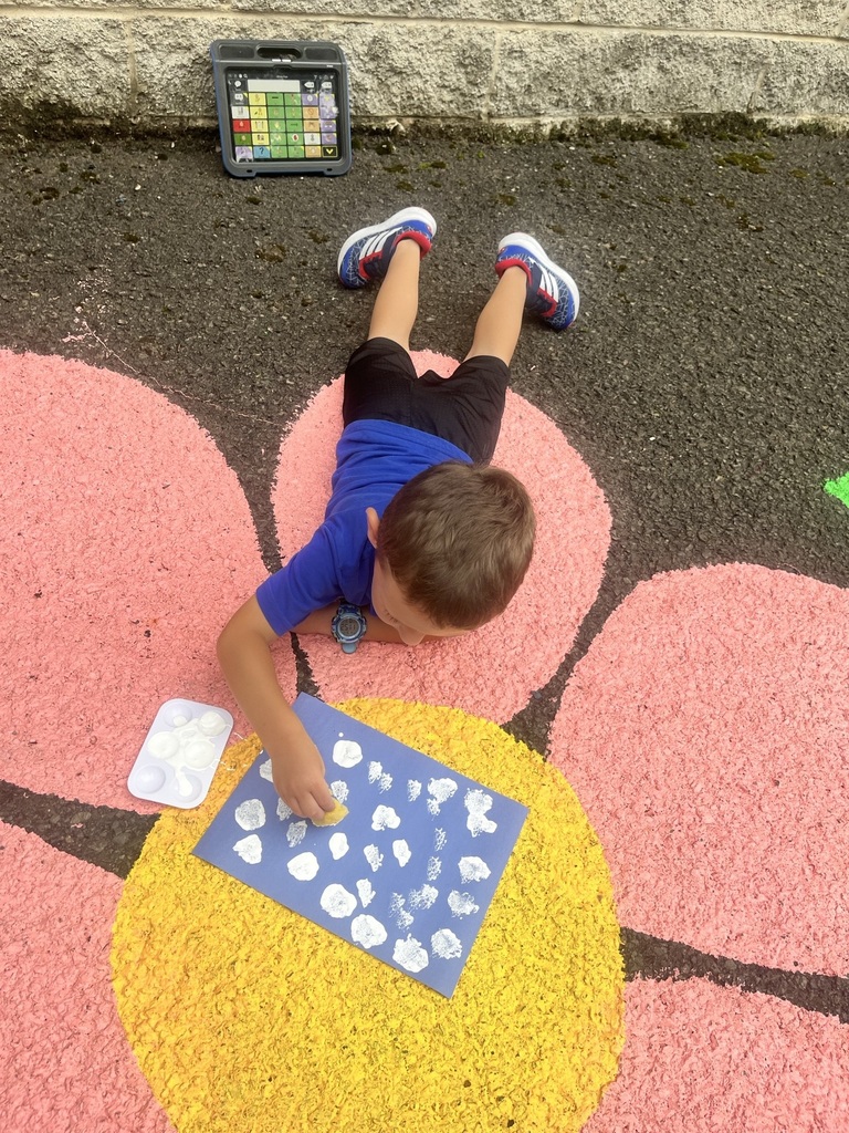 Pre K student painting with a sponge