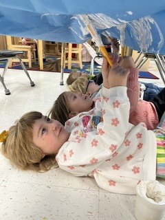 Pre K students painting clouds