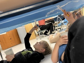 Pre K students painting clouds