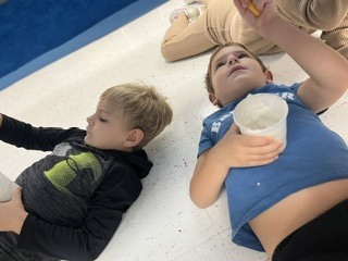 Pre K students painting clouds
