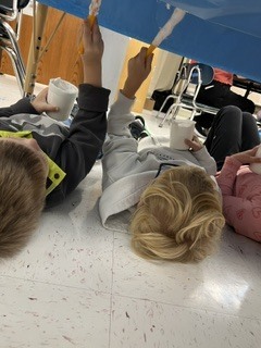 Pre K students painting clouds