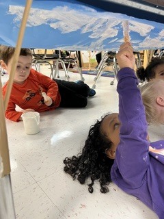 Pre K students painting clouds