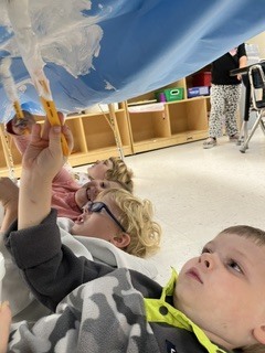 Pre K students painting clouds