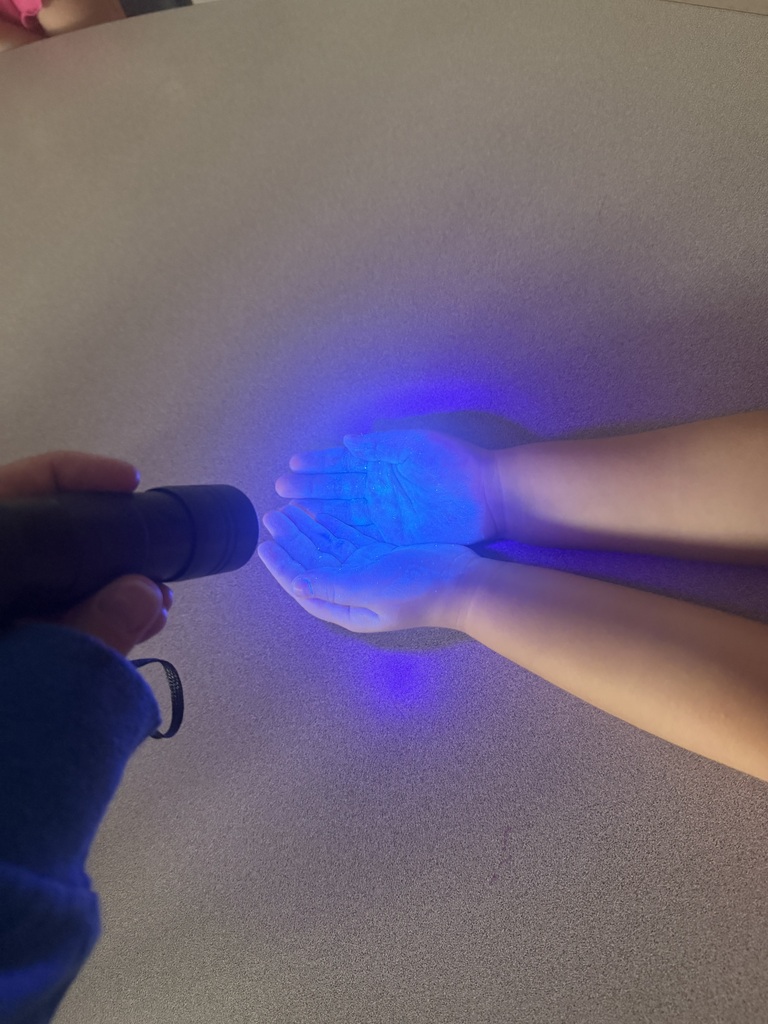 hands under a black light