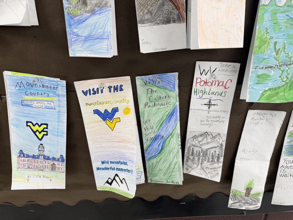 Student made WV brochures hanging on a bulletin board. 