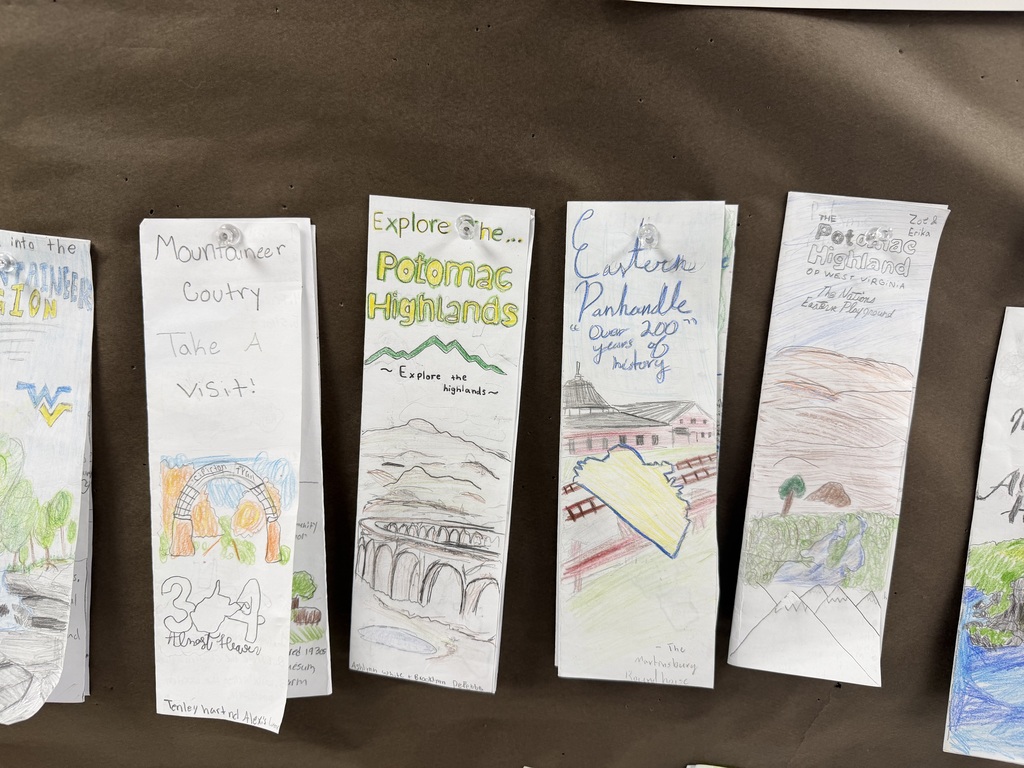 Student made WV brochures hanging on a bulletin board. 