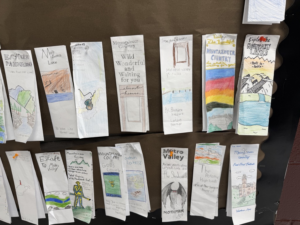 Student made WV brochures hanging on a bulletin board. 