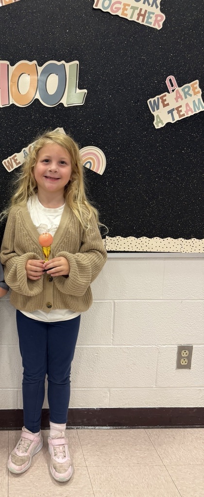 students holding their Student of the Month awards