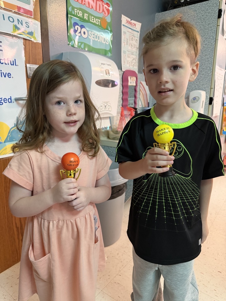 students holding their Student of the Month awards