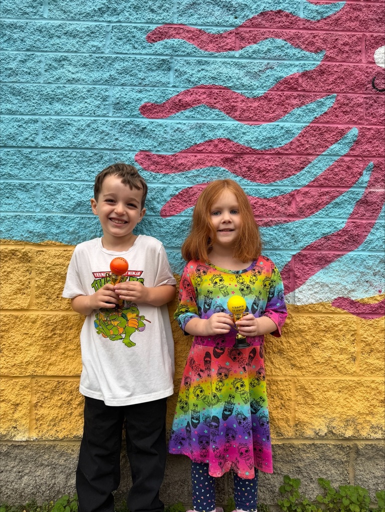students holding their Student of the Month awards