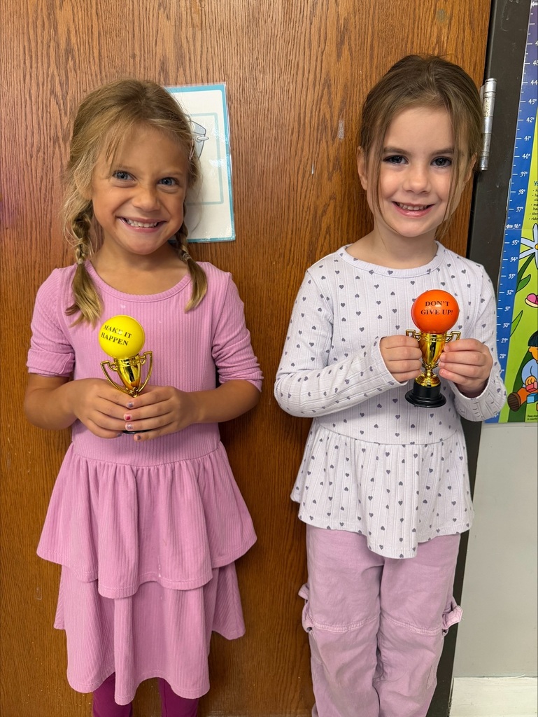 students holding their Student of the Month awards