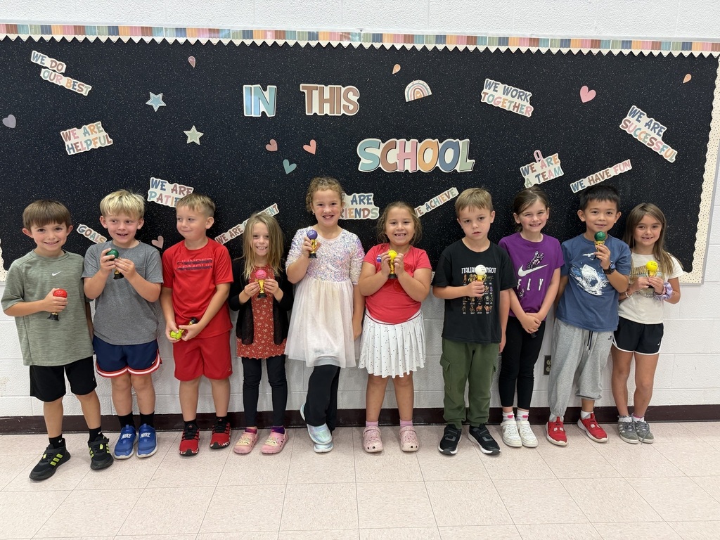 students holding their Student of the Month awards
