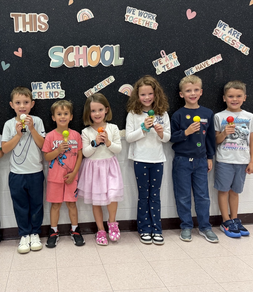 students holding their Student of the Month awards