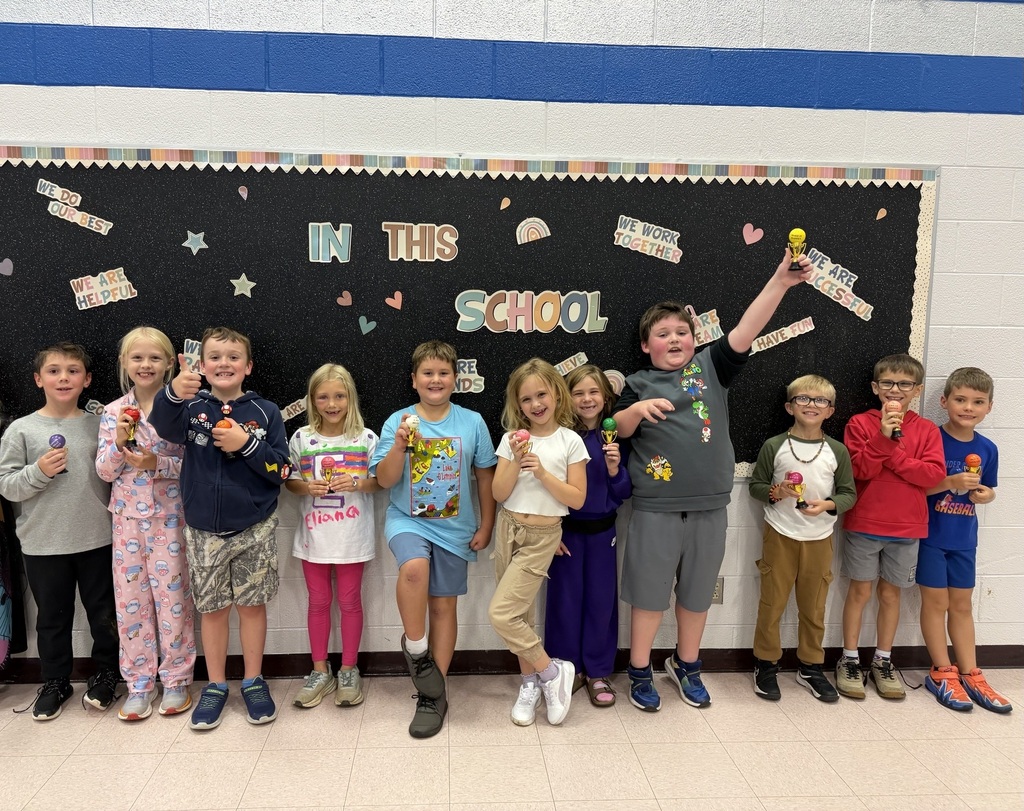 students holding their Student of the Month awards