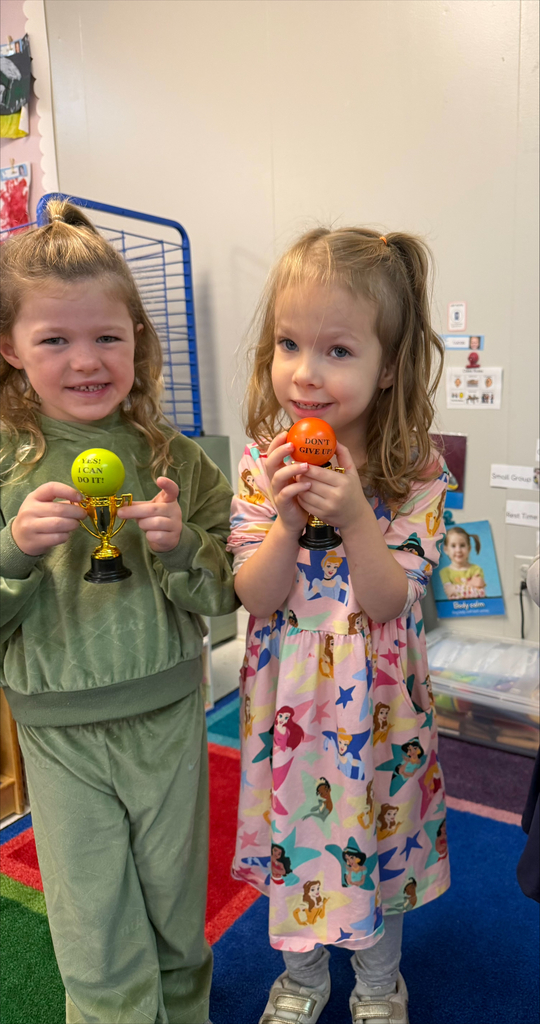 students holding their Student of the Month awards