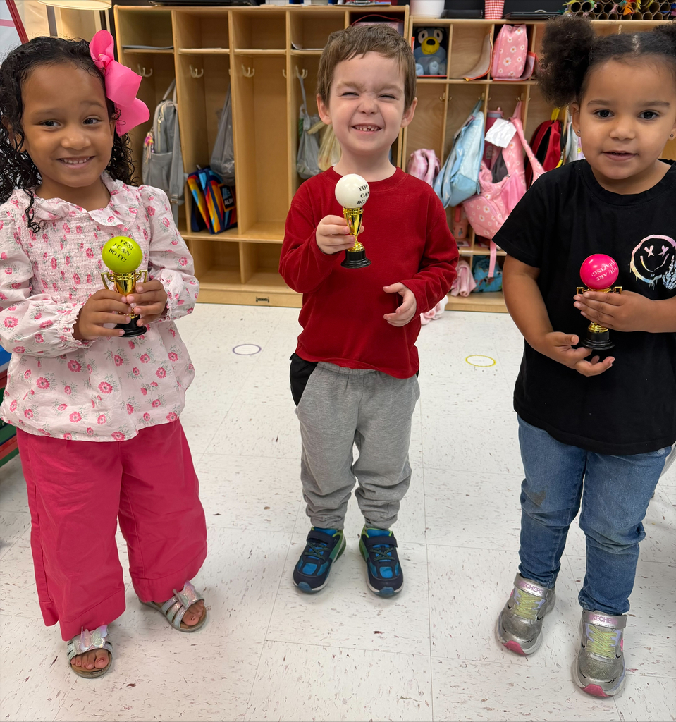 students holding their Student of the Month awards