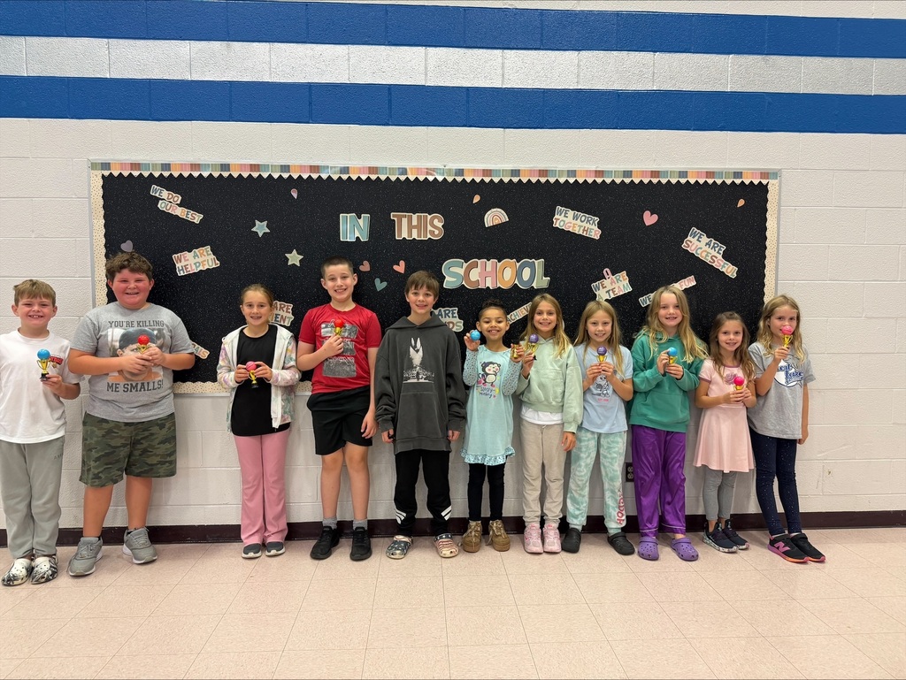 Student of the month holding their trophy
