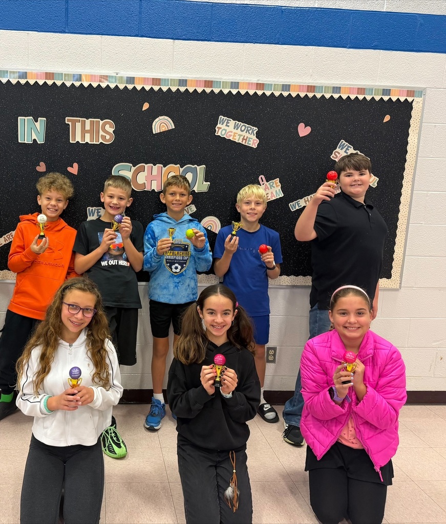 Student of the month holding their trophy
