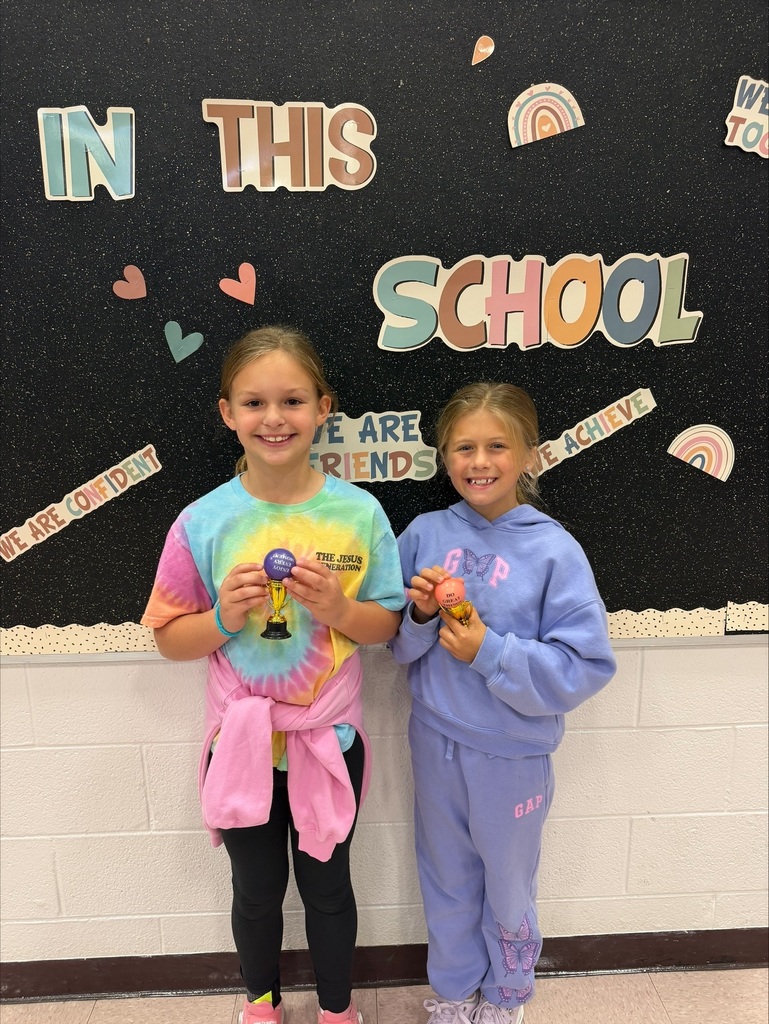 Student of the month holding their trophy