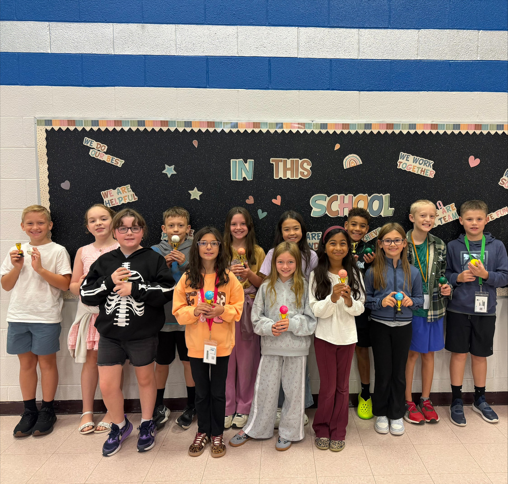 Student of the month holding their trophy