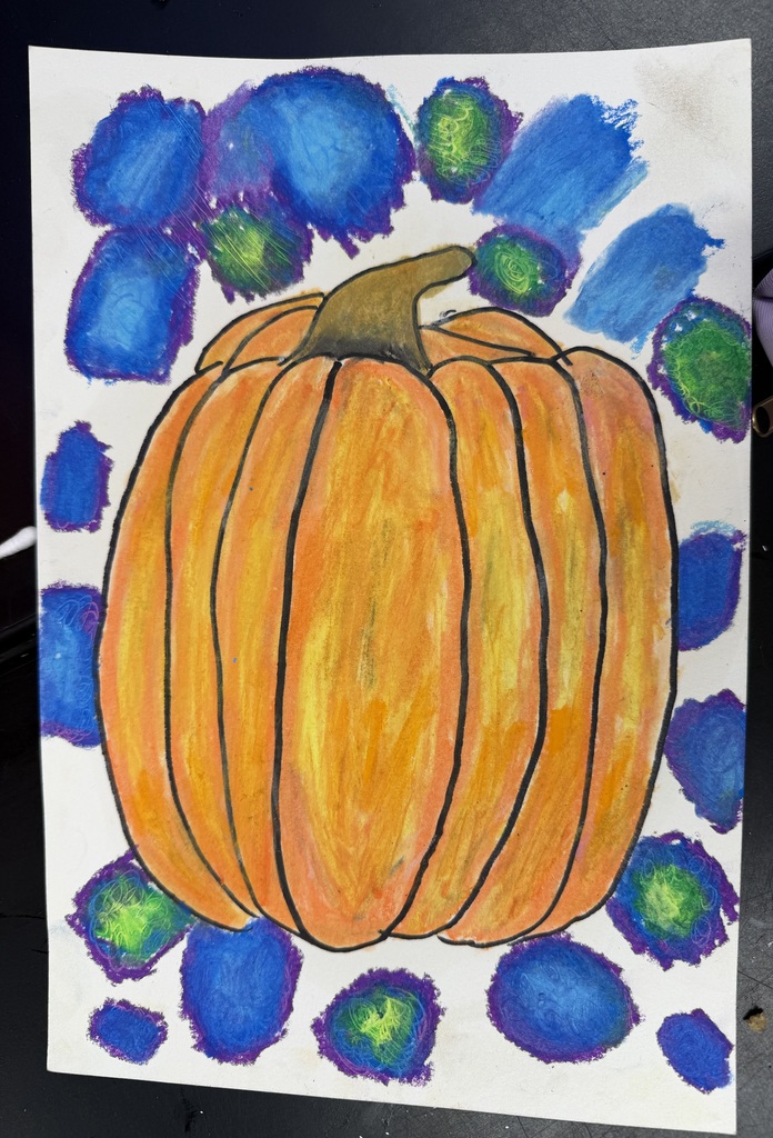 A piece of paper with an orange oil pastel painting of a pumpkin with blue and green spots around it.