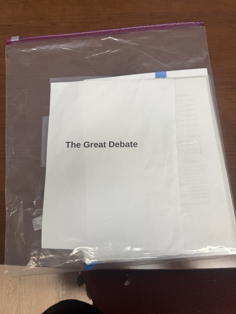 A photo of a plastic bag with a paper in it that says The Great Debate