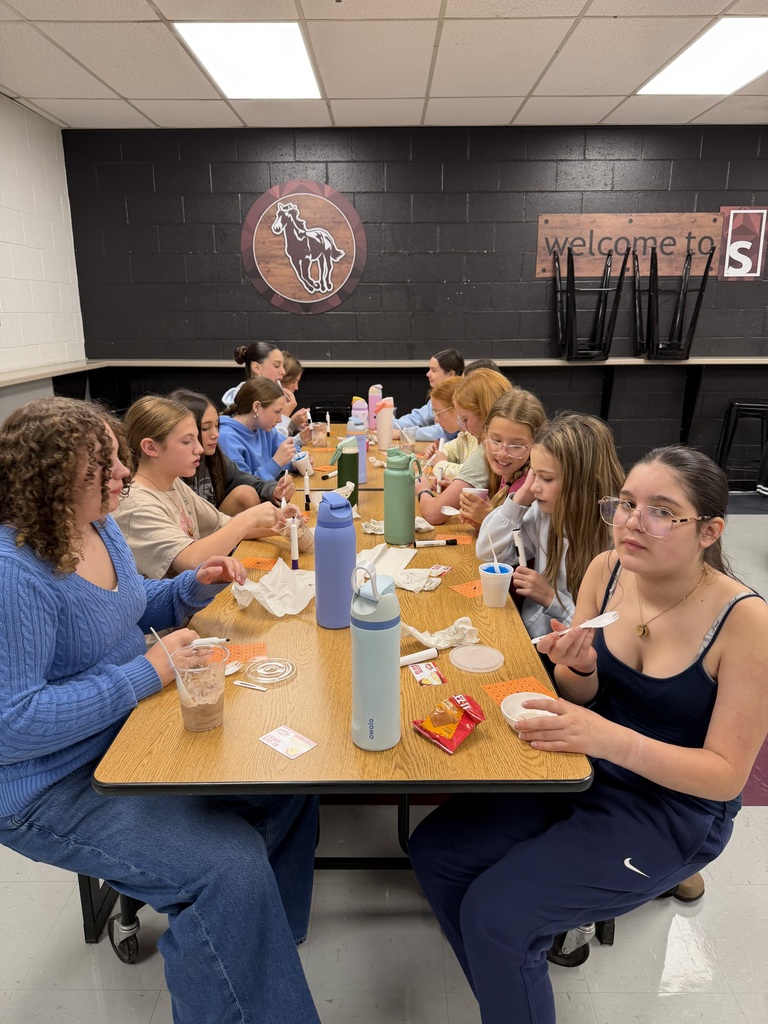 A photo of a table full students eating ice cream and slushies.