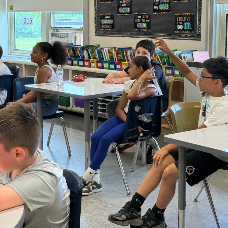 student raising hand in class