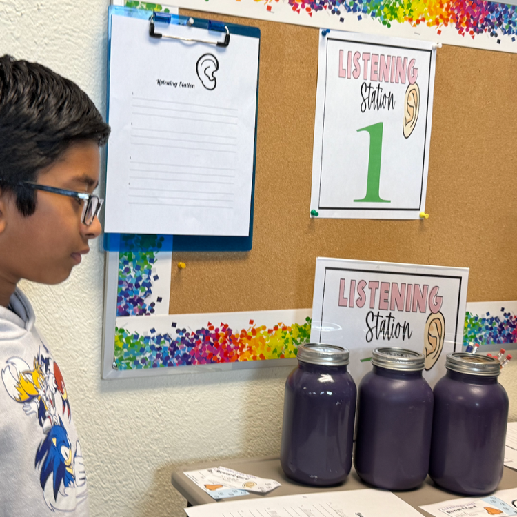 student wearing colorful shirt next to three purple bottles