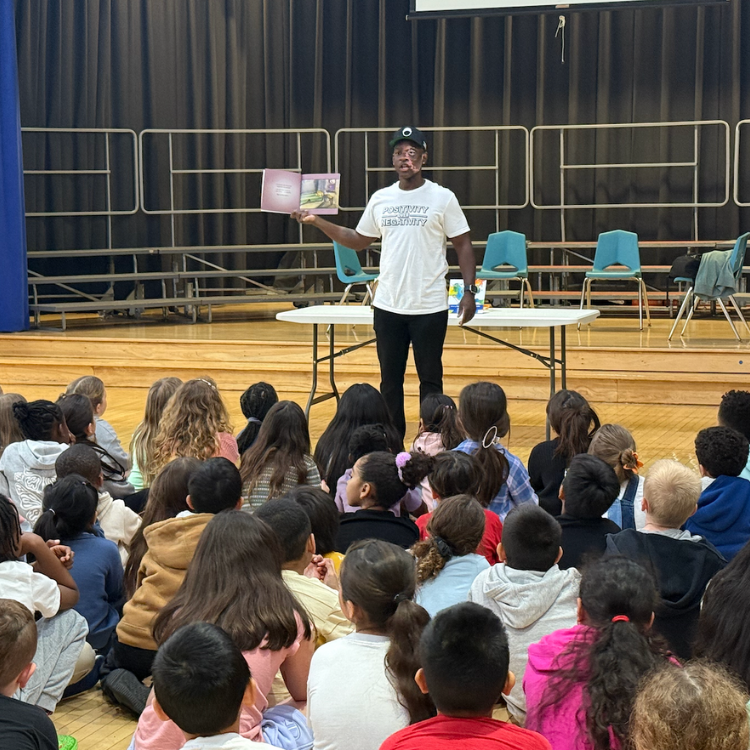man wearing a white shirt with black pants at an assembly