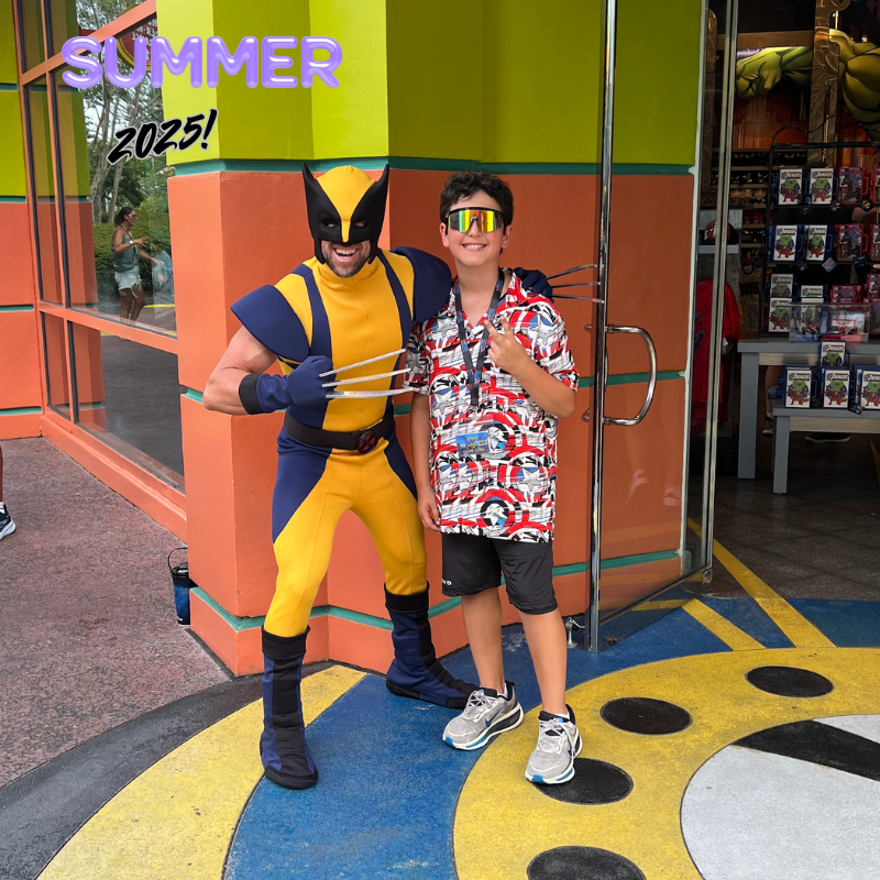 boy with colorful shirt and black shorts posing with wolverine in blue and yellow costume 