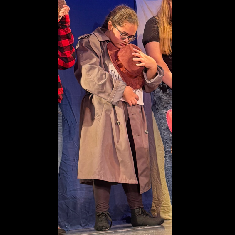 girl wearing a brown jacket and black shoes