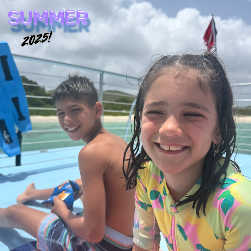 girl and boy wearing colorful bathing suits on a beach 