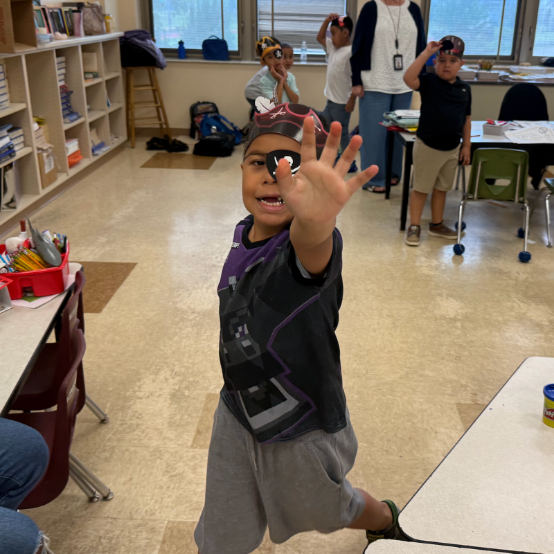 student with a pirate hat and black and purple shirt