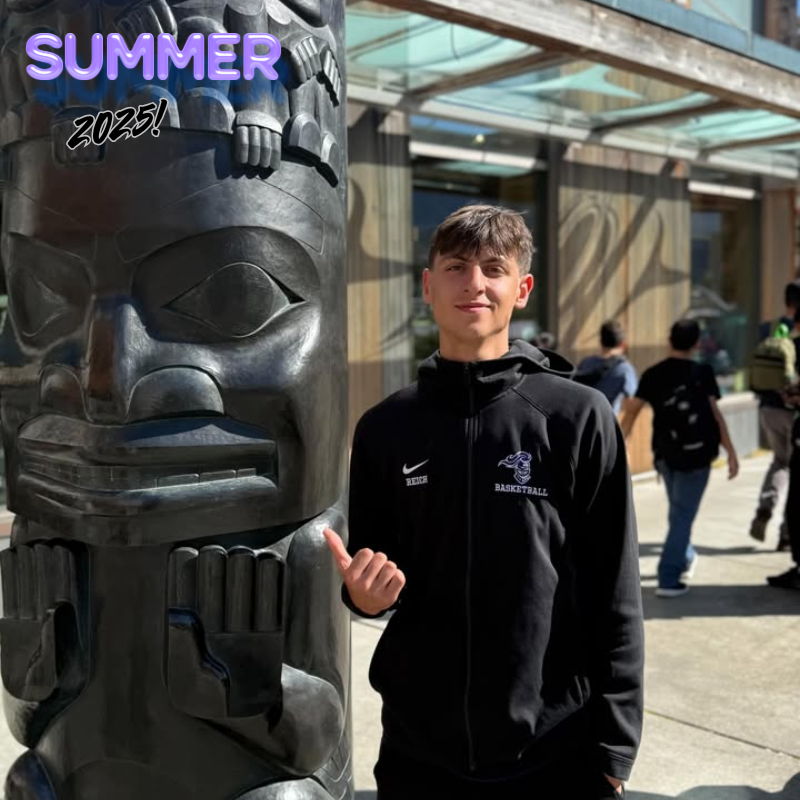 student in all black next to a black statue
