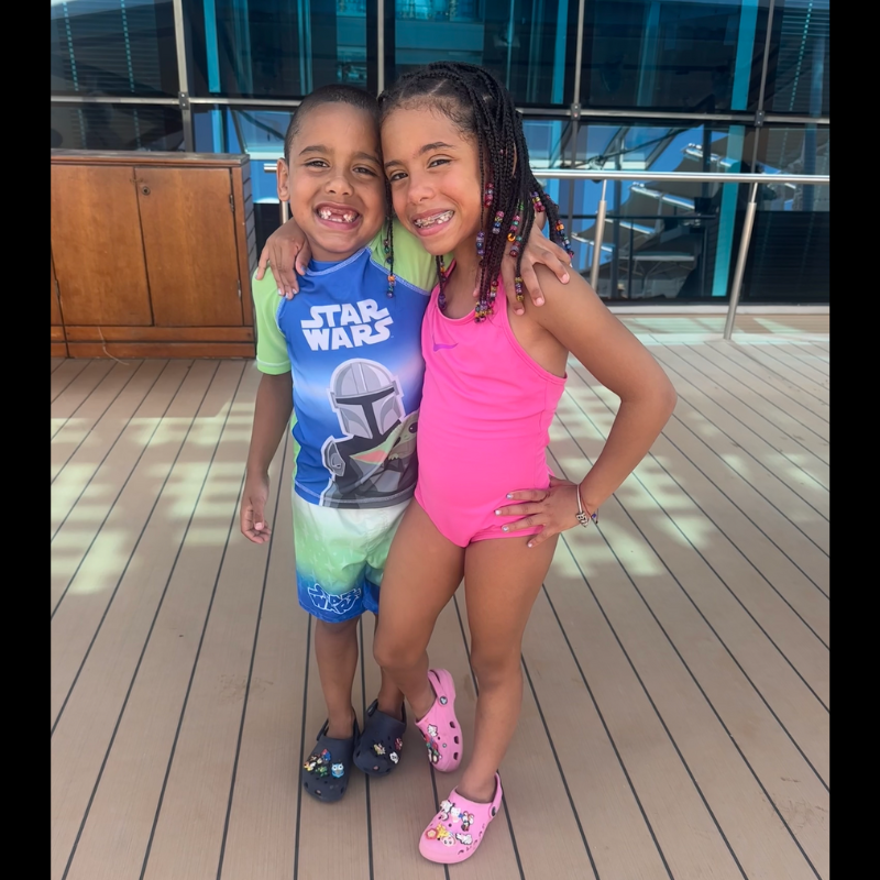 two students on a boardwalk wearing pink and blue bathing suits