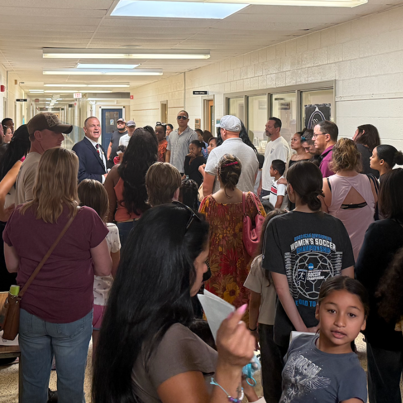families standing in a hallway