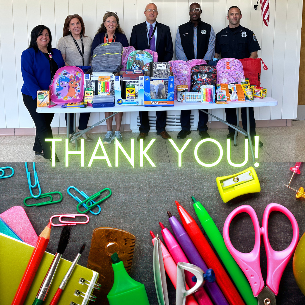 village representatives and school employees with school supplies