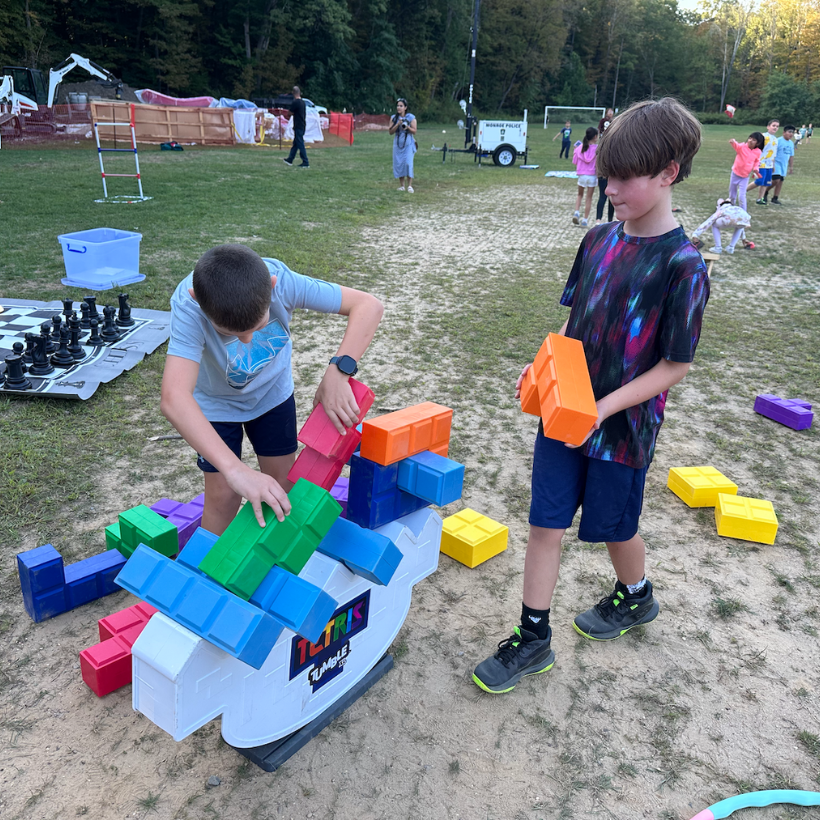 two students playing with a colorful tetris game 