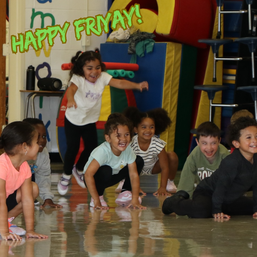 students jumping and smiling in gym class